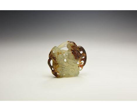 An undated archaistic pale green and brown jade(?) pendant in the form of a man seated on the back of a lion with scrolling t