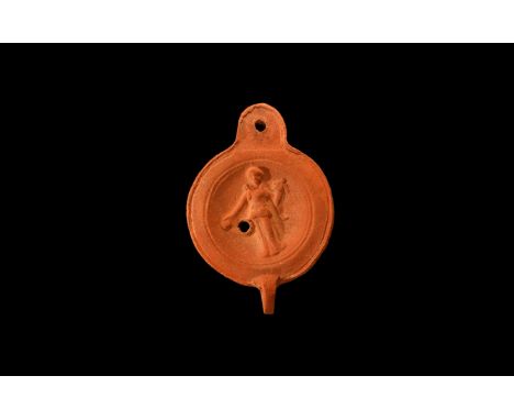 An undated archaistic ceramic redware oil lamp in 2nd-3rd century AD style, with round nozzle and flat rim to the shoulder, r