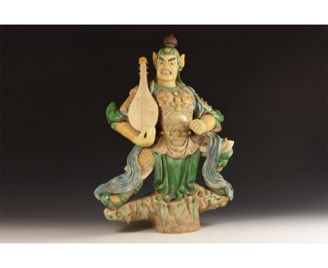 20th century AD. A polychrome glazed ceramic figure of Guan Yu with helmet, cuirass and vambraces; to the right hand a string