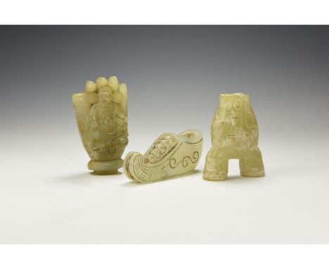 An undated archaistic group of three jade(?) items consisting of: a deer head toggle with engraved details to the face and ea