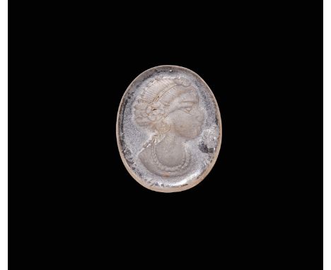 An oval glass undated archaistic plaque with intaglio female profile bust wearing a diadem and necklace.  4.24 grams, 28mm (1