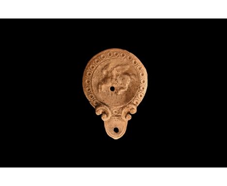An dated archaist ceramic buff coloured oil lamp in 1st-2nd century AD style, with rounded nozzle and pelta shaped volutes to