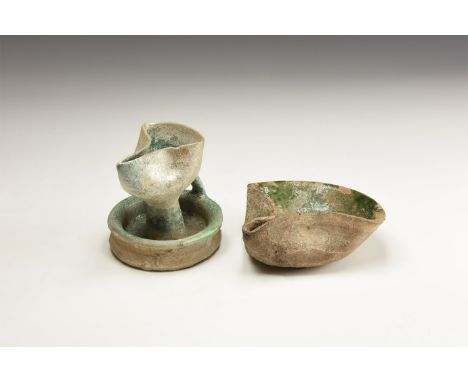 A group of undated archaistic iridescent glazed ceramic oil lamps comprising: one a dish with folded and pinched nozzle; one 