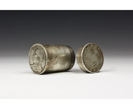 An undated archaistic silver-coloured metal tubular box, lid and base made from a coin with portrait and Chinese characters; 