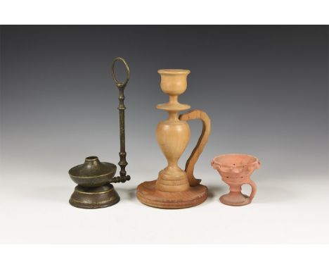 A mixed group of undated archaistic items comprising: a terracotta lamp with loop handle below the cup with turretted edge; a