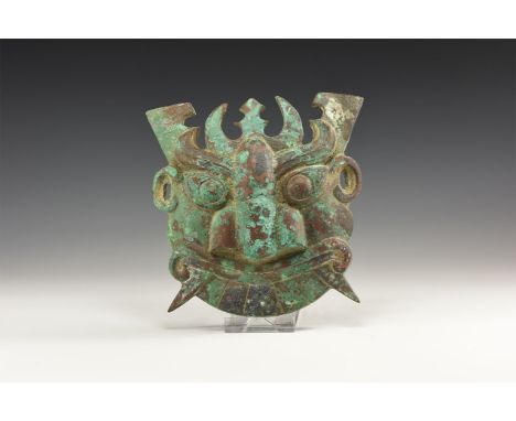 An undated archaistic Western Zhou Period style mask with large almond shaped eyes, curving eyebrows and large flat nose with