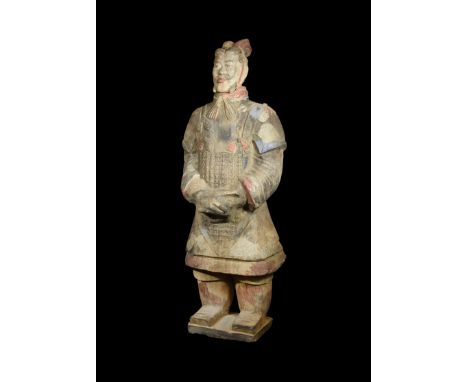 A very large undated archaistic hollow-formed ceramic figurine of a standing warrior with hands folded, dressed in a loose fl