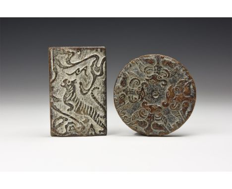 A pair of undated ceramic plaques, one rectangular with high-relief tiger and the other discoid with central hole and fenghua