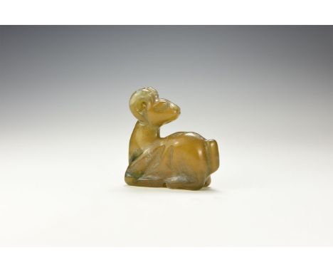 An undated archaistic jade(?) figure of a reclining ibex, head turned back, horns arching back to the neck.  85 grams, 60mm (