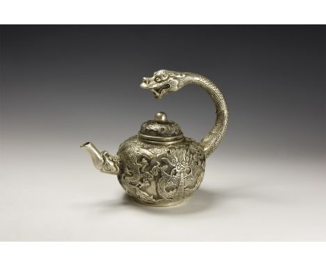 An undated archaistic silver-coloured metal teapot with handle formed as a dragon head, a low-relief dragon decoration to the