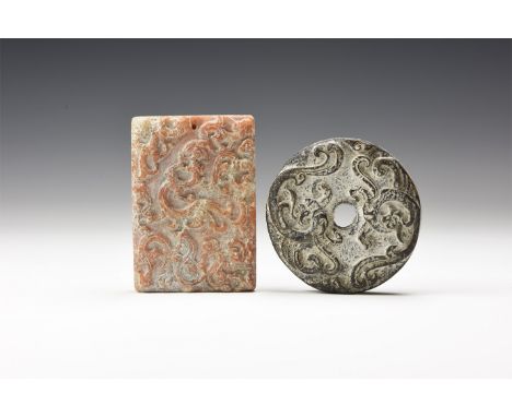 A pair of undated ceramic plaques, one rectangular with high-relief lizards and the other discoid with central hole and drago
