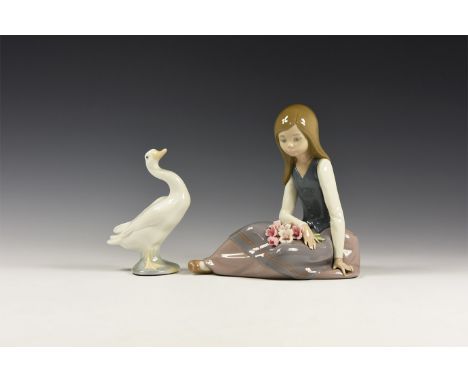 20th century AD. A glazed ceramic figure group comprising a girl sitting with a bunch of flowers on her lap and a goose with 