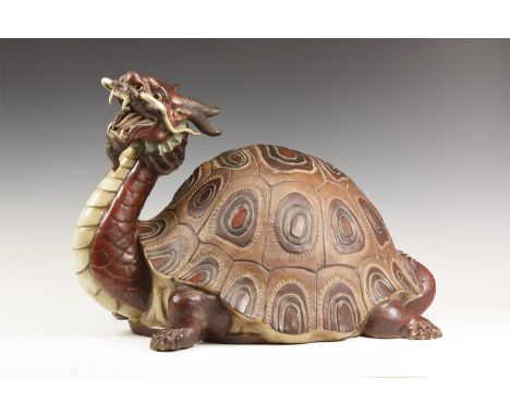 20th century AD. A glazed ceramic figure of a turtle with extended neck and dragon's head; hollow to the underside.  6.2 kg, 