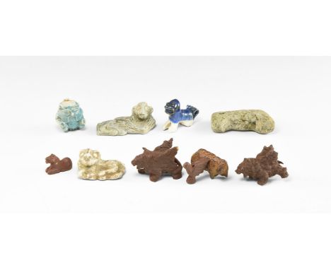 20th century AD. A group of ten copper alloy, ceramic and glass figures consisting: two reclining lions, a carved stone with 