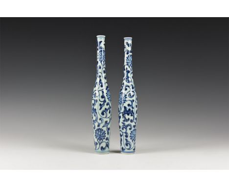 19th- early 20th century AD. A pair of glazed ceramic minature vases with slender body, elongated neck, blue flower and folia