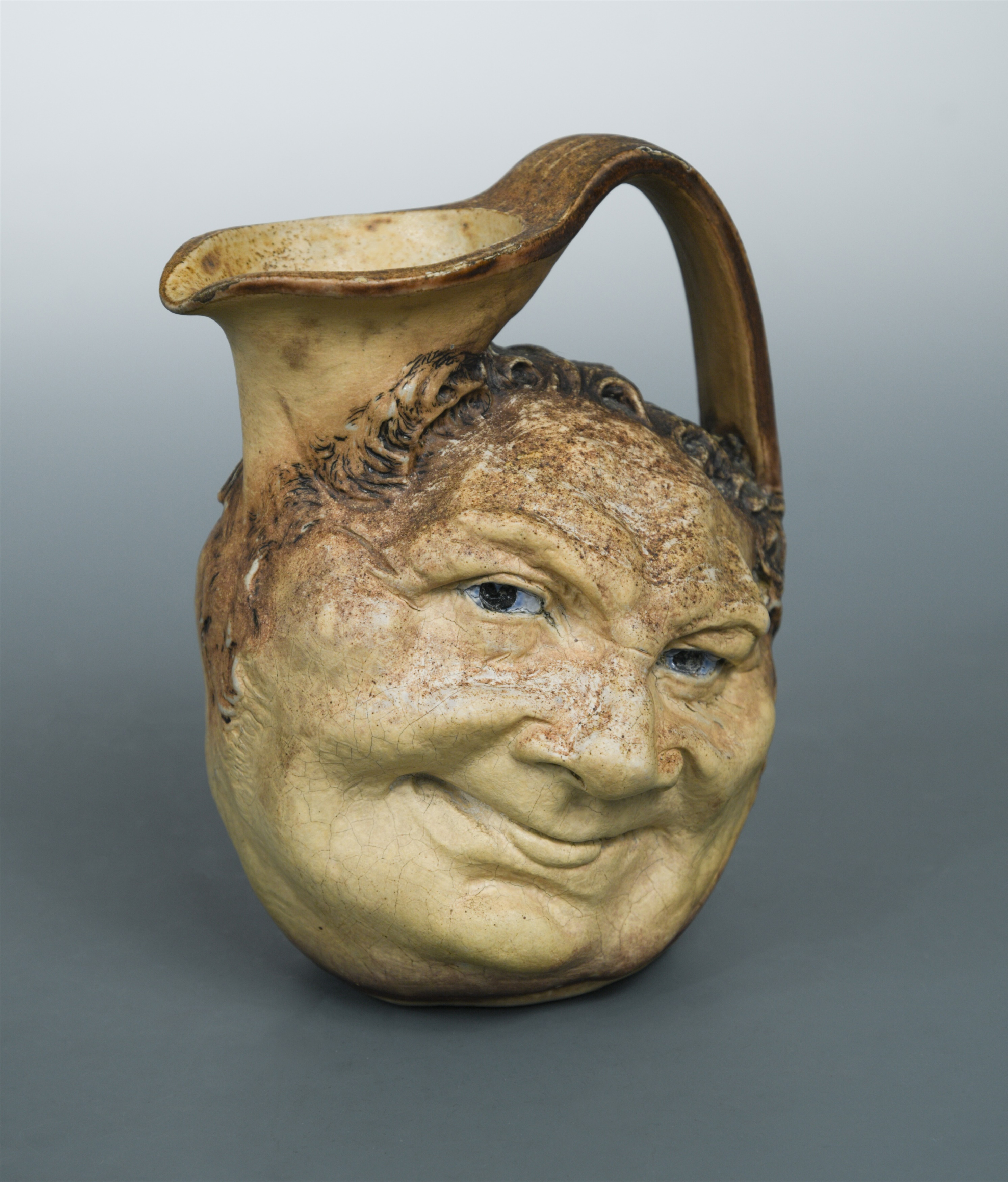Robert Wallace Martin for Martin Brothers, a stoneware face jug, 1900, in Cheffins Fine Art