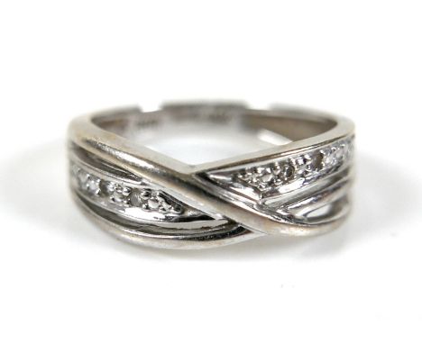 An 18ct white gold and diamond crossover ring, size I, 3.0g.Missing one small diamond 