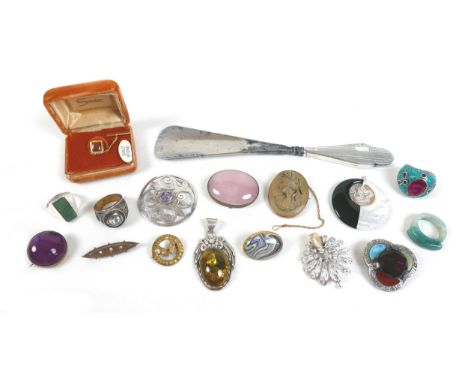 A small group of costume jewellery, including a silver pendant set with an amber style cabochon, an oval rose quartz brooch, 