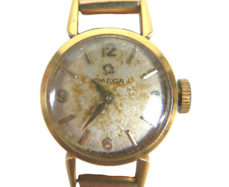 An Omega 9ct gold lady's wristwatch, on a 9ct gold articulated bracelet strap with safety chain, 13.8g gross. 