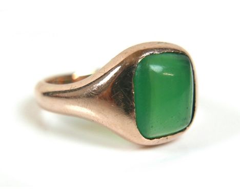 An Edwardian 9ct yellow gold signet ring, set with a rectangular cabochon green stone, 11 by 10mm, 13.5mm at widest, band 3.5