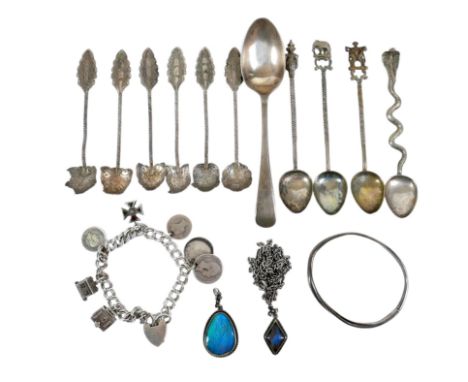 A group of silver jewellery, comprising a charm bracelet, with 19th century coins, miniature bible, and cross shaped charm se