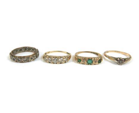 A group of three 9ct gold dress rings, including an emerald and diamond ring, size K, 1.4g, a diamond solitaire ring, with 1m