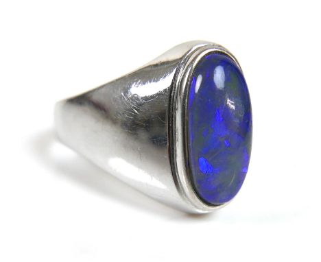 An 18ct white gold ring, set with an oval opal, 13.0 by 6.5mm, on a plain tapering band, size P, 5.1g. 