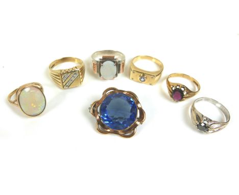 A group of five 9ct gold rings, including one set with an oval opal, 18 by 14mm, size Q, a white gold gypsy ring set with a r