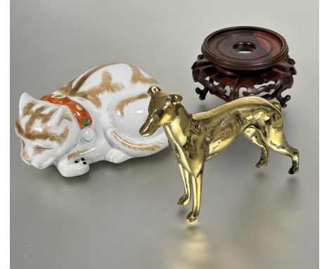 A cast brass Greyhound standing door stop figure H 14cm, a modern Chinese porcelain curled sleeping cat figure L x 18cm and a