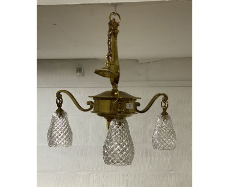 An Edwardian cast gilt brass ceiling light fitting, the three cut glass shades on scrolling branches issuing from a central c