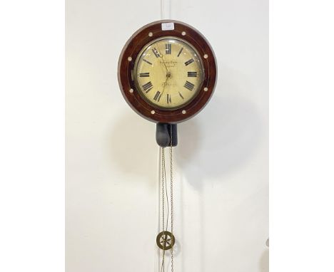 A 19th century wag on the wall clock, the circular mahogany case with mother of pearl inlay enclosing a cream painted dial wi