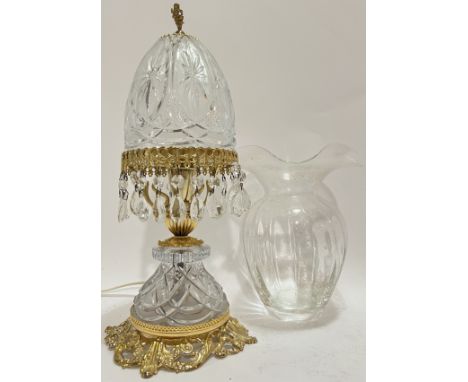 A moulded glass lamp lustre with gilt scrolling foliate mounts and putto/cherub finial (h- 41cm), together with a quatrefoil 