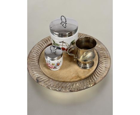 An Edwardian Epns circular fluted bread board with wood inset D x 28cm, an Epns panelled christening mug and a large and smal
