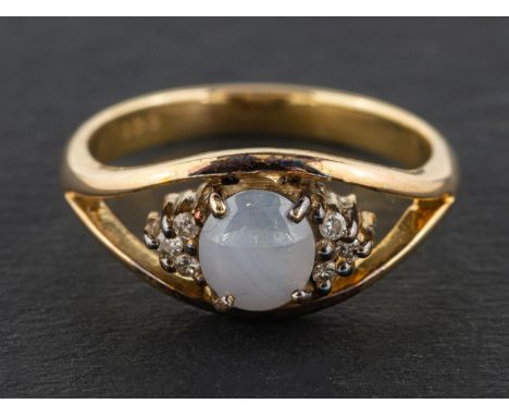 A cabochon-cut, oval, grey star sapphire and round, brilliant-cut diamond ring, estimated sapphire weight ca. 1.20ct, total e