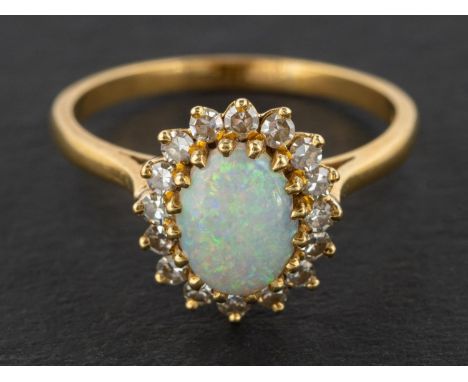 An 18ct gold, oval, cabochon-cut opal and single-cut diamond cluster ring, total estimated diamond weight ca. 0.40ct, with ha