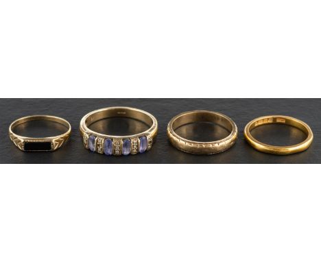 Four rings, including a 9ct gold onyx ring; a 9ct gold band ring; a 22ct gold band ring; a kyanite and single-cut diamond rin