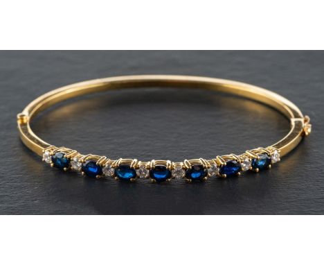 An oval, mixed-cut sapphire and round, brilliant-cut diamond hinged bangle, total estimated sapphire weight, ca. 3cts, total 
