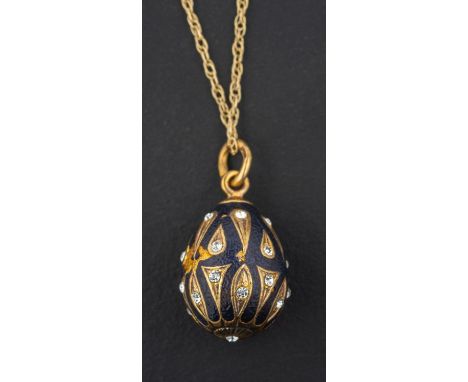 A black enamel and white paste, egg-shaped pendant, with control marks for Russia, Moscow, the pendant and chain stamped '925