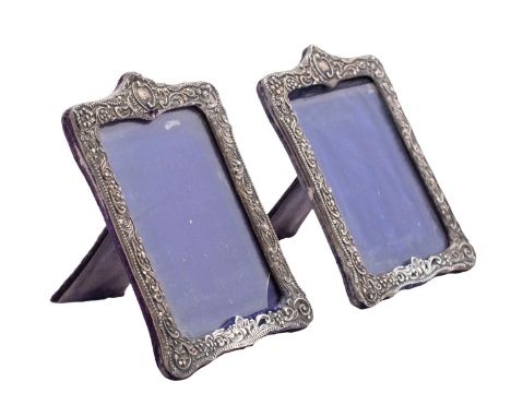 A pair of Edward VII silver easel photograph frames, maker Henry Matthews, Birmingham, 1901 of rectangular outline, 18 x 12.5