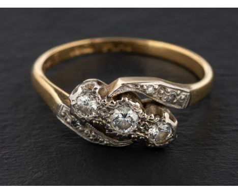 A single and round, brilliant-cut diamond cross-over ring, total estimated weight of principal diamonds ca. 0.20ct, H-I colou