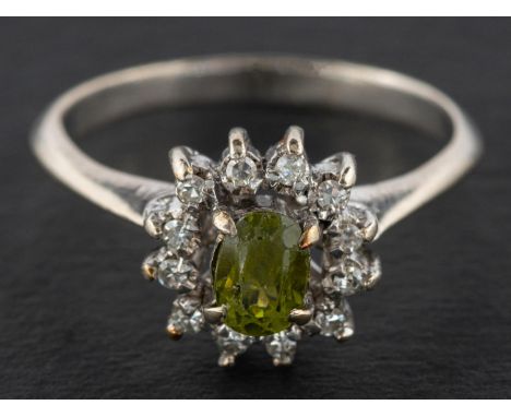 A peridot and single-cut diamond cluster ring, estimated weight of peridot ca. 0.65ct, stamped '18K', length of ring head ca.
