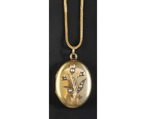 An oval locket pendant with seed pearl decoration in floral motif, together with a fox-tail link chain, stamped '750', length