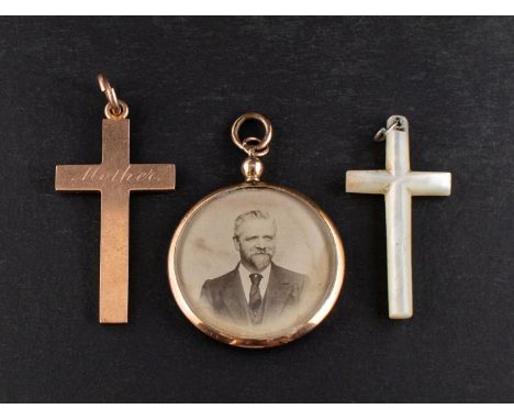 Three pendants, including a 9ct gold cruciform pendant, engraved 'Mother', a mother-of-pearl cruciform pendant and a 9ct gold