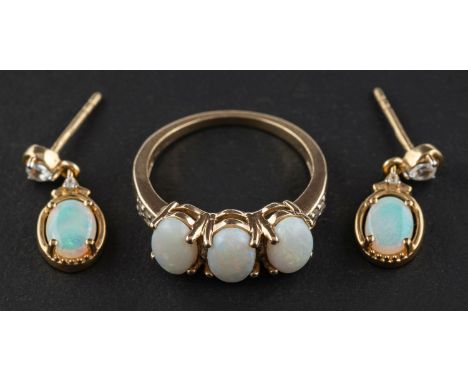 An oval cabochon-cut opal, three-stone ring, with white paste to shoulders, stamped 10K, ring size N, together with a pair of