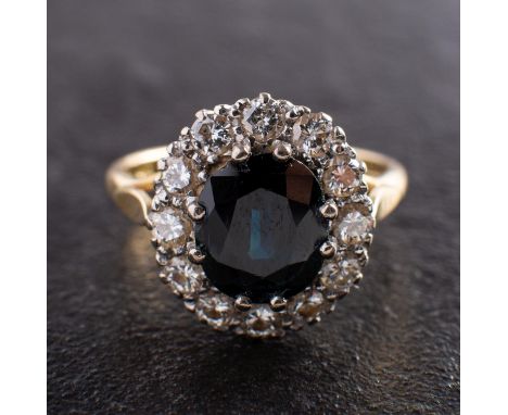 An oval, mixed-cut sapphire and round, brilliant-cut diamond cluster ring, engraved with sapphire weight 2.66 and total diamo