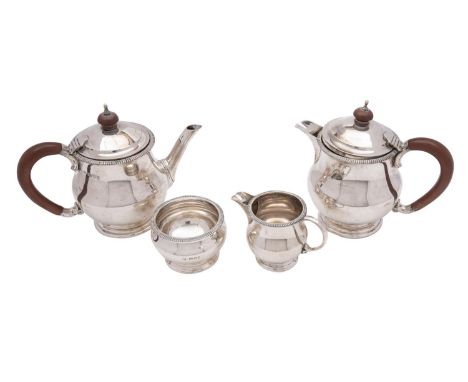 A George VI silver four-piece tea service, maker Mappin &amp; Webb, London, 1938 of ovoid form with beaded borders, raised on