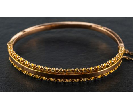 A late Victorian, 9ct gold, hinged bangle, with rope-work and ball decoration to borders, with sponsor's mark Smith & Ewen, a