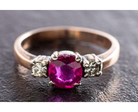 A ruby and round, brilliant-cut diamond three-stone ring, estimated ruby weight ca. 0.55ct, estimated total diamond weight ca