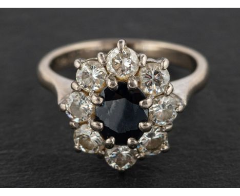 A sapphire and round, brilliant-cut diamond cluster ring, estimated sapphire weight ca. 0.75ct, total estimated diamond weigh