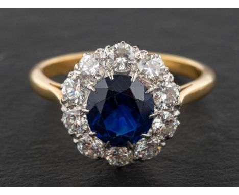 An oval, mixed-cut sapphire and round, brilliant-cut diamond cluster ring, estimated sapphire weight ca. 2cts, total estimate